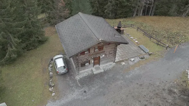 Horizontal video: Aerial view of rustic cabin surrounded by forest 29033101. Duration: 15 seconds. Resolution: 3840x2160