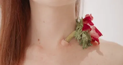 Horizontal video: A woman with a flower on her neck 4273394. Duration: 13 seconds. Resolution: 4096x2160