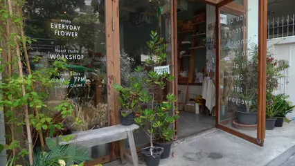 Horizontal video: Woman carrying a basket of flowers inside her shop 5404956. Duration: 12 seconds. Resolution: 3840x2160