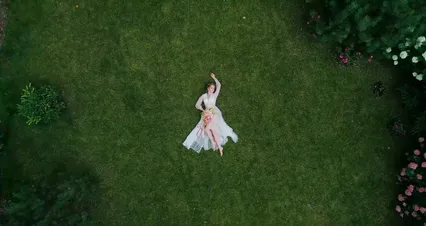 Horizontal video: A bride lying on grass 8419637. Duration: 7 seconds. Resolution: 4096x2160