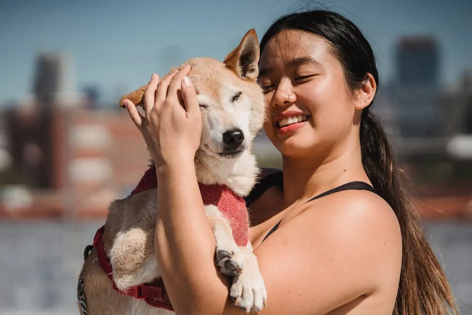 A happy woman embraces her fluffy dog in a sunny outdoor setting, showcasing their strong bond.