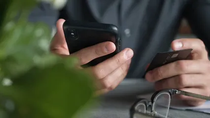 Horizontal video: Person holding cellphone and card 7535099. Duration: 9 seconds. Resolution: 1920x1080