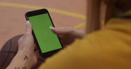 Horizontal video: Woman scrolling a phone with green screen 6077614. Duration: 10 seconds. Resolution: 4096x2160