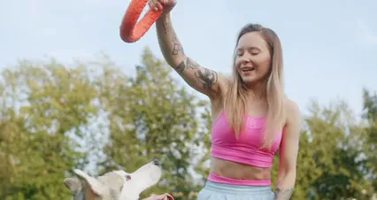 Horizontal video: A woman training her dog at the park 9631741. Duration: 15 seconds. Resolution: 4096x2160