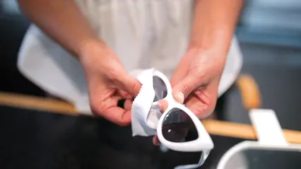 Horizontal video: A person cleaning sunglasses 5241175. Duration: 20 seconds. Resolution: 1920x1080