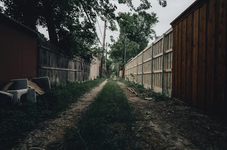 Dirt Road Between Wooden Fences
