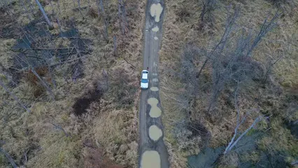 Horizontal video: An aerial view of a road in the middle of a marsh 19409609. Duration: 33 seconds. Resolution: 3840x2160