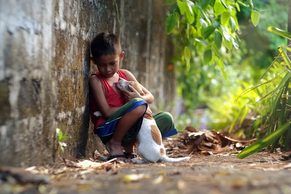 Boy Sitting and Hugging a Dog