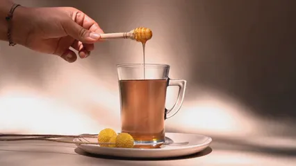 Horizontal video: A person adding honey in a tea using a honey dipper 7615792. Duration: 15 seconds. Resolution: 1920x1080