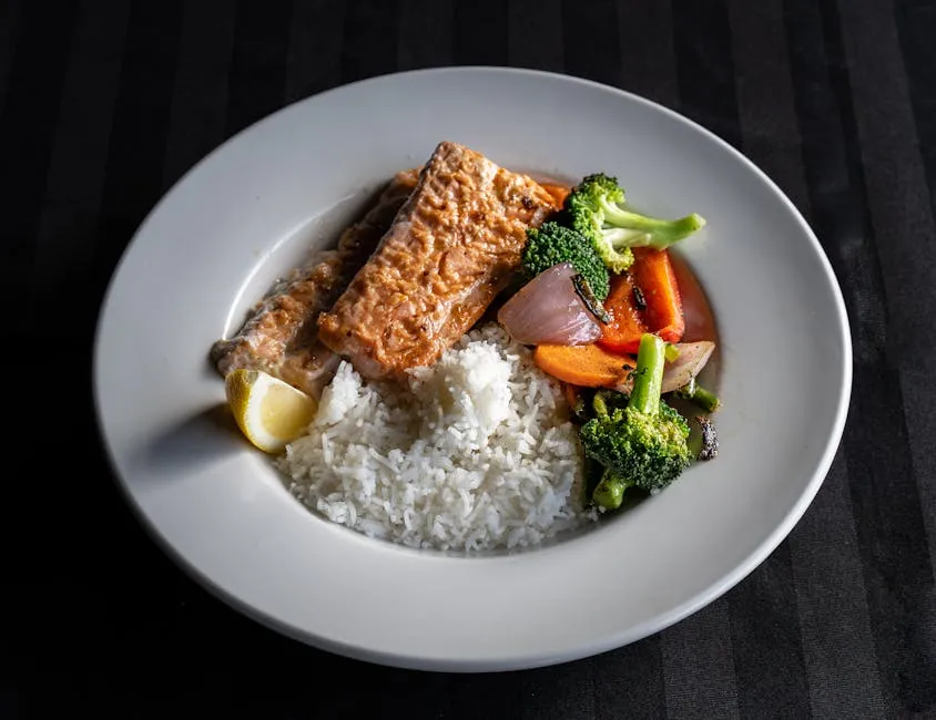 A Salmon with Stir Fry Vegetables and Rice on the Side