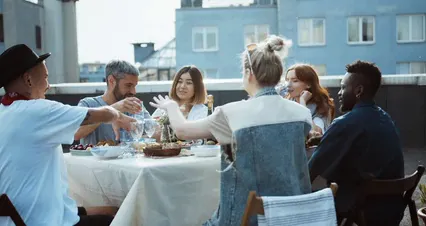 Horizontal video: A group of people sitting at a table on a rooftop 4877896. Duration: 28 seconds. Resolution: 4096x2160