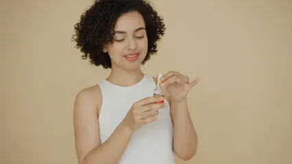 Horizontal video: A woman applying essential oil over her cheek 6706920. Duration: 16 seconds. Resolution: 1920x1080