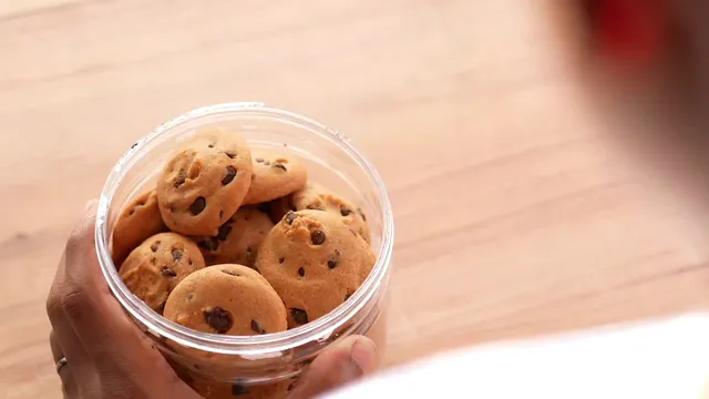 Horizontal video: Person reaching into cookie jar 11132813. Duration: 9 seconds. Resolution: 3840x2160