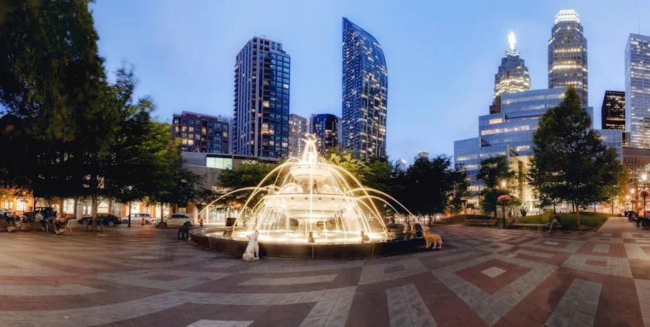 Illuminated Water Fountain near Buildings 