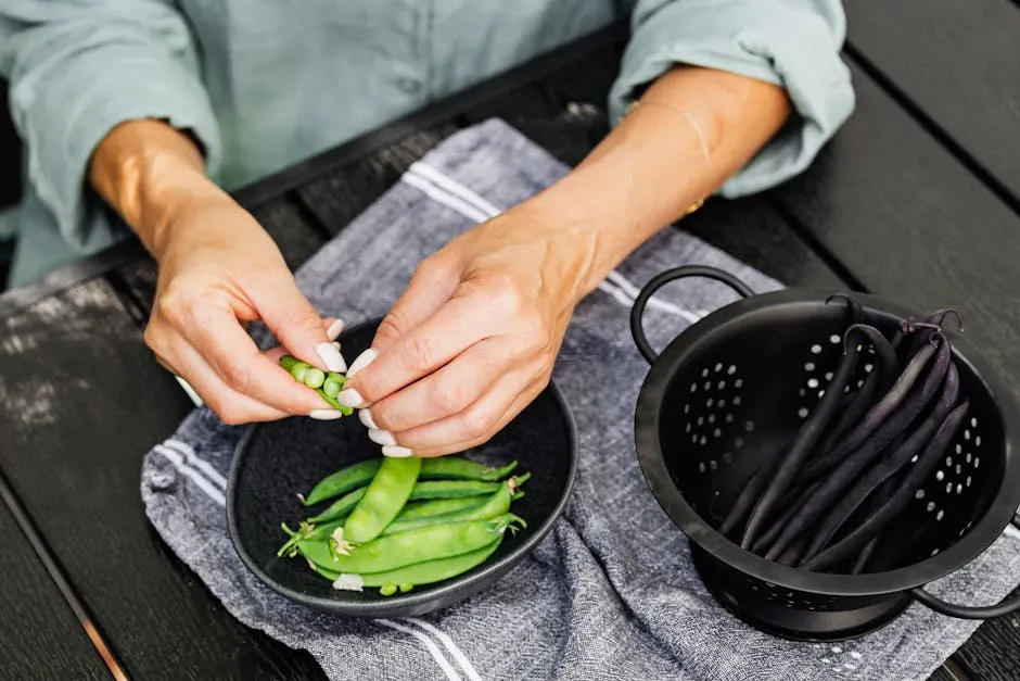 Person Holding Green Vegetable on Black Round Plate