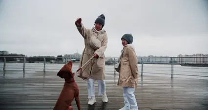 Horizontal video: A mother and her daughter playing with their dog 9508475. Duration: 42 seconds. Resolution: 4096x2160