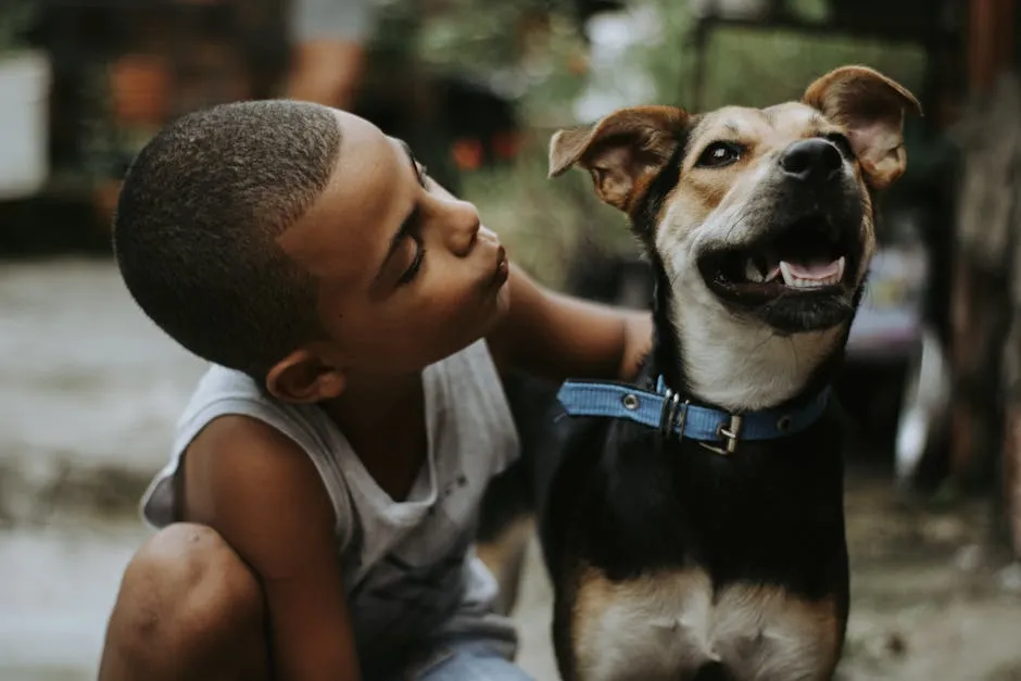 A heartwarming scene of a child kissing his pet dog outside, capturing their bond.