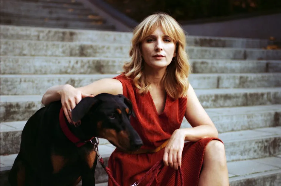 Woman Sitting on the Stairs Outside with Her Dog 