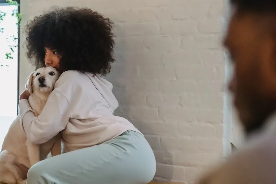Side view of calm African American female with short curly hair in casual clothes embracing obedient dog while spending time with boyfriend in light room in daytime