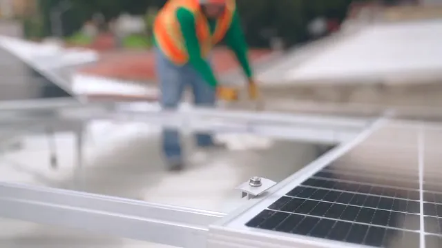 Horizontal video: Two men mounting solar panels with clamps 8853485. Duration: 19 seconds. Resolution: 1920x1080