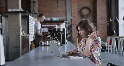 Horizontal video: Woman in floral shirt using her laptop while a man served her coffee 4828604. Duration: 37 seconds. Resolution: 4096x2160