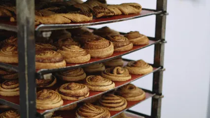 Horizontal video: Rack of fresh cinnamon rolls 5930354. Duration: 17 seconds. Resolution: 3840x2160