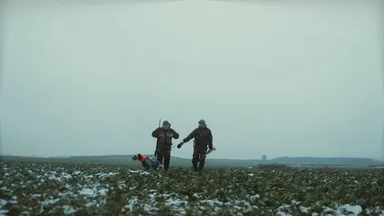 Horizontal video: Men in uniform walking with a dog 6200834. Duration: 22 seconds. Resolution: 3840x2160