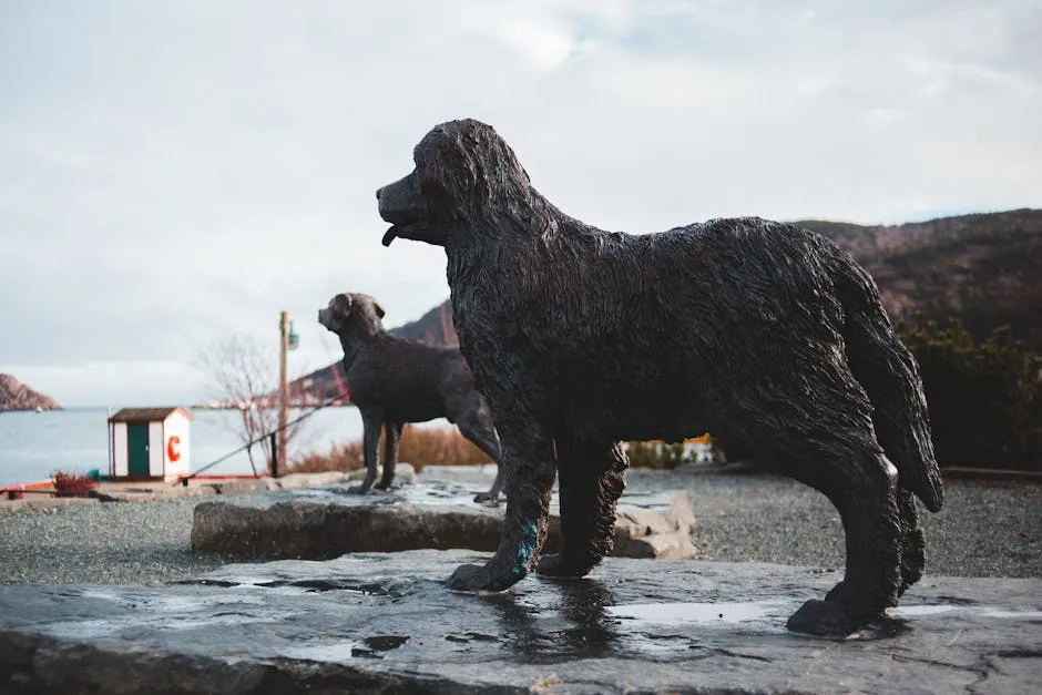 Bronze dog statues in an outdoor memorial park by the seaside, captured on a cloudy day.