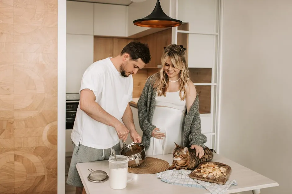 Husband and Wife preparing Food together with their Cat 