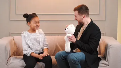 Horizontal video: Man giving girl a stuffed toy 7424129. Duration: 12 seconds. Resolution: 3840x2160