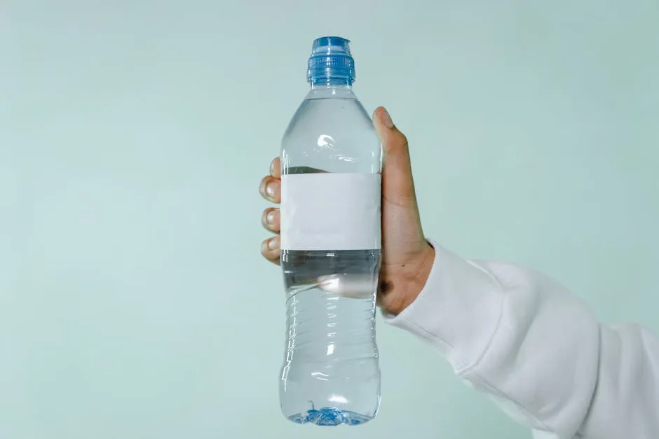 Person Holding Clear Plastic Bottle