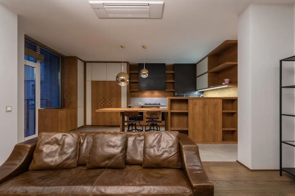 Spacious and stylish living room with leather sofa and contemporary kitchen.