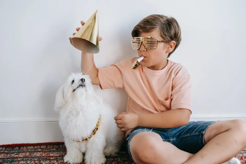 Young boy with Maltese dog celebrating indoors, wearing party accessories.