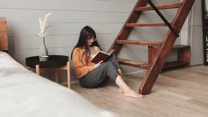 Horizontal video: A woman reading a book and petting her dog 6825114. Duration: 10 seconds. Resolution: 3840x2160