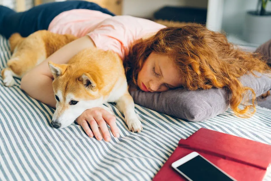 Redhead woman and Shiba Inu dog sleeping together on a striped bed indoors, creating a cozy scene.