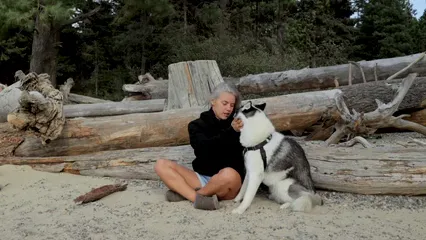 Horizontal video: Woman sitting on the ground while petting a dog 9354036. Duration: 12 seconds. Resolution: 1920x1080