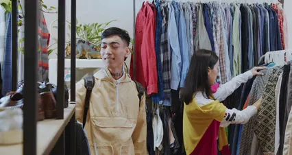Horizontal video: A woman choosing clothes on a rack 6120423. Duration: 17 seconds. Resolution: 4096x2160