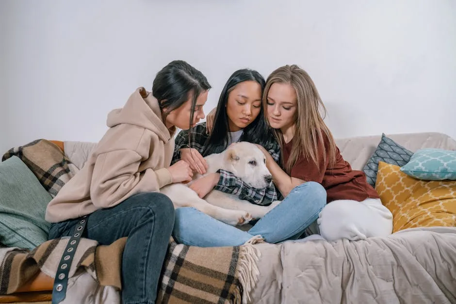 Three women sitting on a couch comforting with a dog, symbolizing support and friendship.