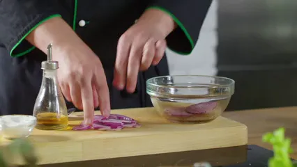 Horizontal video: A person tossing onion slices on a crystal bowl with olive oil 3195370. Duration: 26 seconds. Resolution: 3840x2160