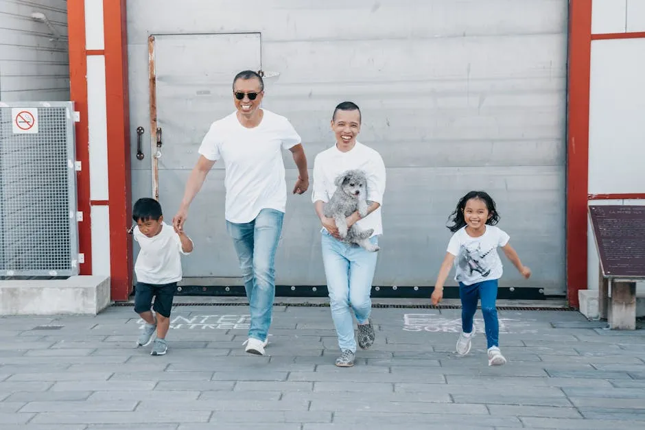 Joyful family with pet dog running outdoors, expressing happiness and togetherness.