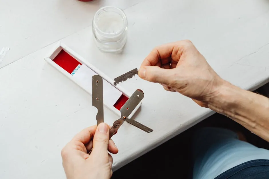 Photo of a Person's Hand Holding a Razor Blade