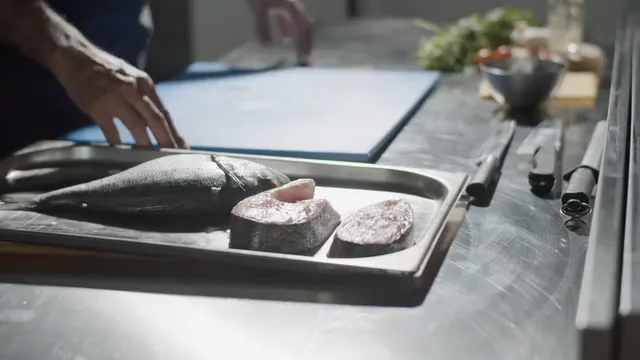 Horizontal video: Chef preparing the fish in kitchen 8626089. Duration: 11 seconds. Resolution: 3840x2160