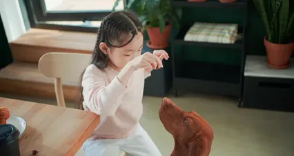 Horizontal video: A woman sitting at a table with a dog 9509232. Duration: 33 seconds. Resolution: 4096x2160